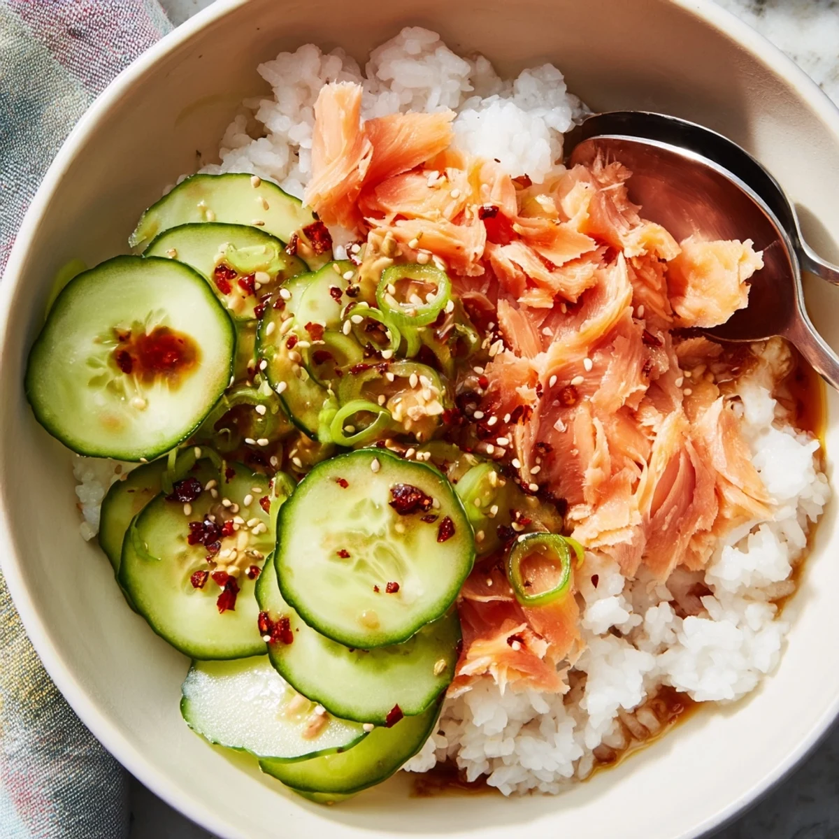 Colorful Leftover Salmon & Rice Bowl featuring steamed rice and succulent salmon flakes. 