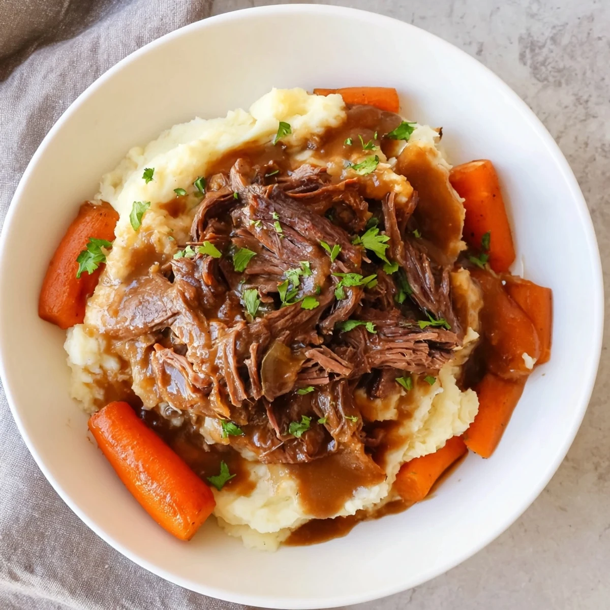 A close-up of a steaming Slow Cooker Pot Roast with vibrant vegetables and creamy potatoes.