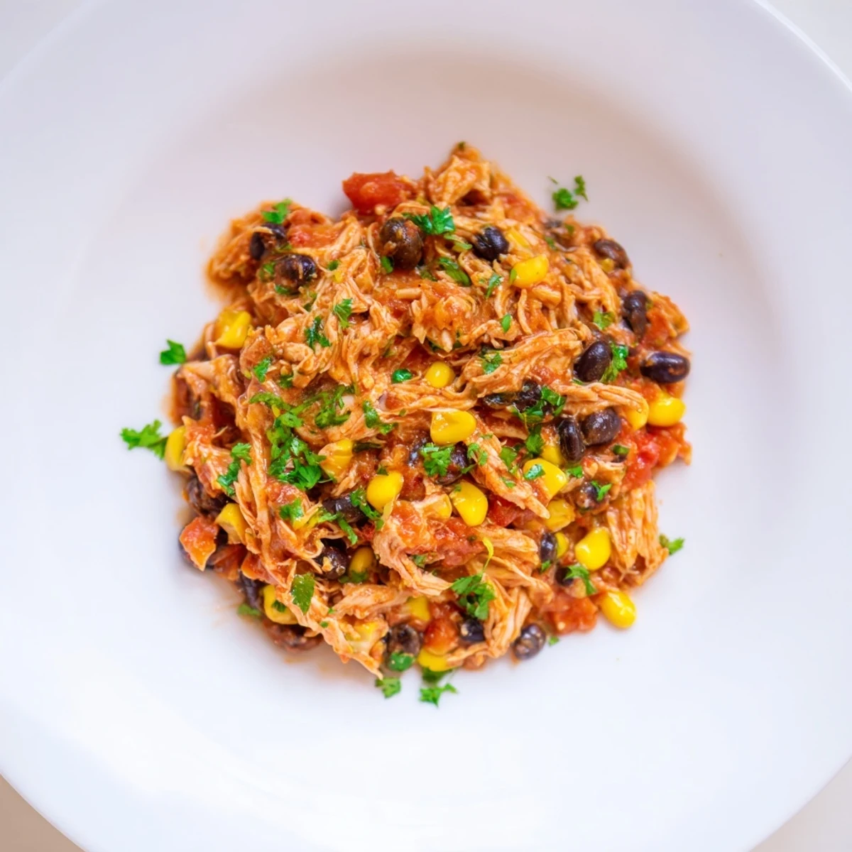 Slow cooker salsa chicken, deliciously shredded, ready to fill warm tortillas with flavorful filling for dinner.