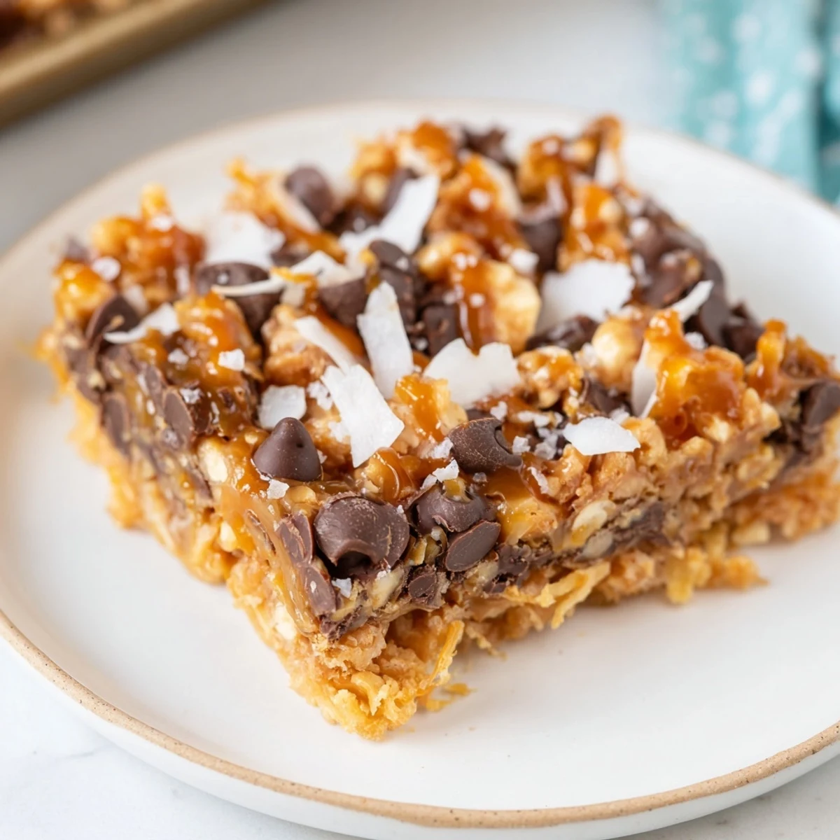 Warm and gooey 7-Layer Magic Bars showing off layers of chocolate chips and nuts, perfect for dessert.