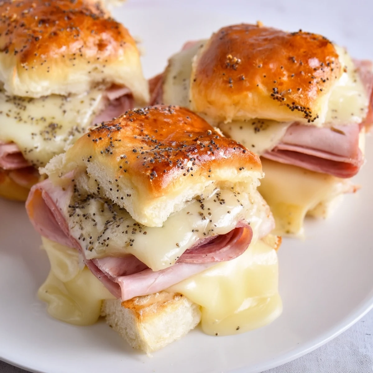 Baked Ham and Cheese Party Sliders, golden and bubbly, perfect for a party appetizer, ready to enjoy.