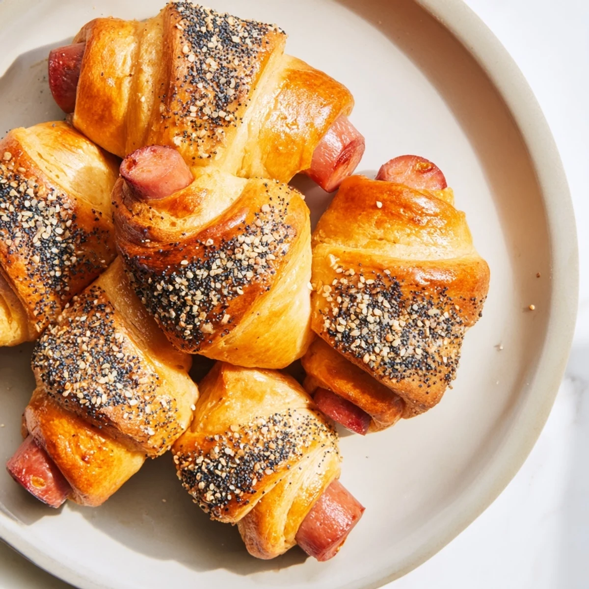 Warm Everything Bagel Pigs in a Blanket with a crispy crust and everything bagel seasoning.