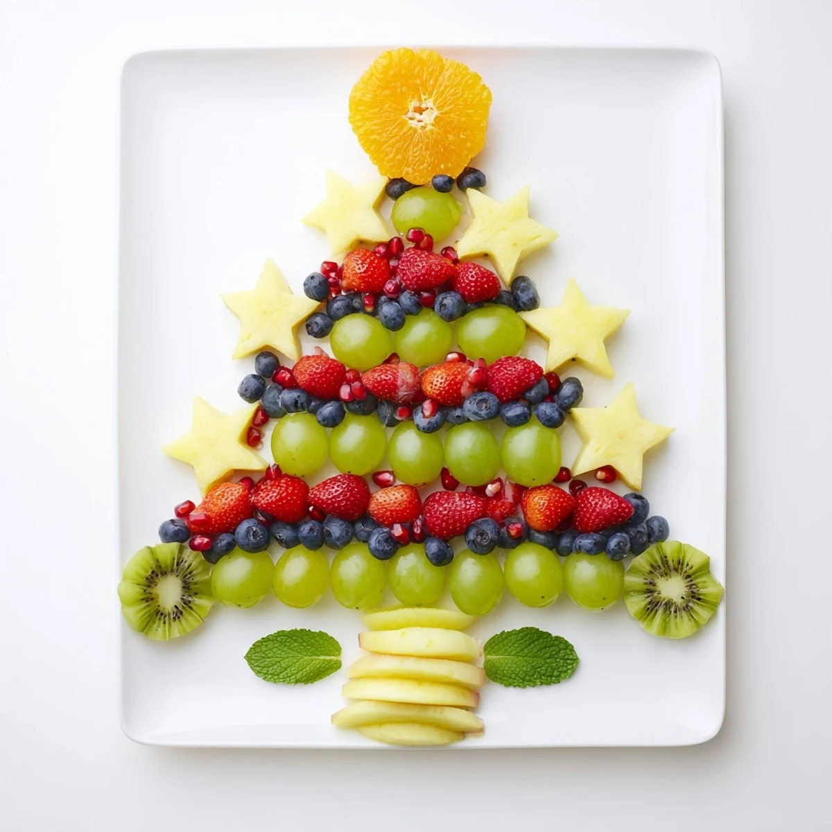 Festive Quick Christmas Tree Fruit Platter glistening with fresh grapes, strawberries, and fun star-shaped pineapple pieces.