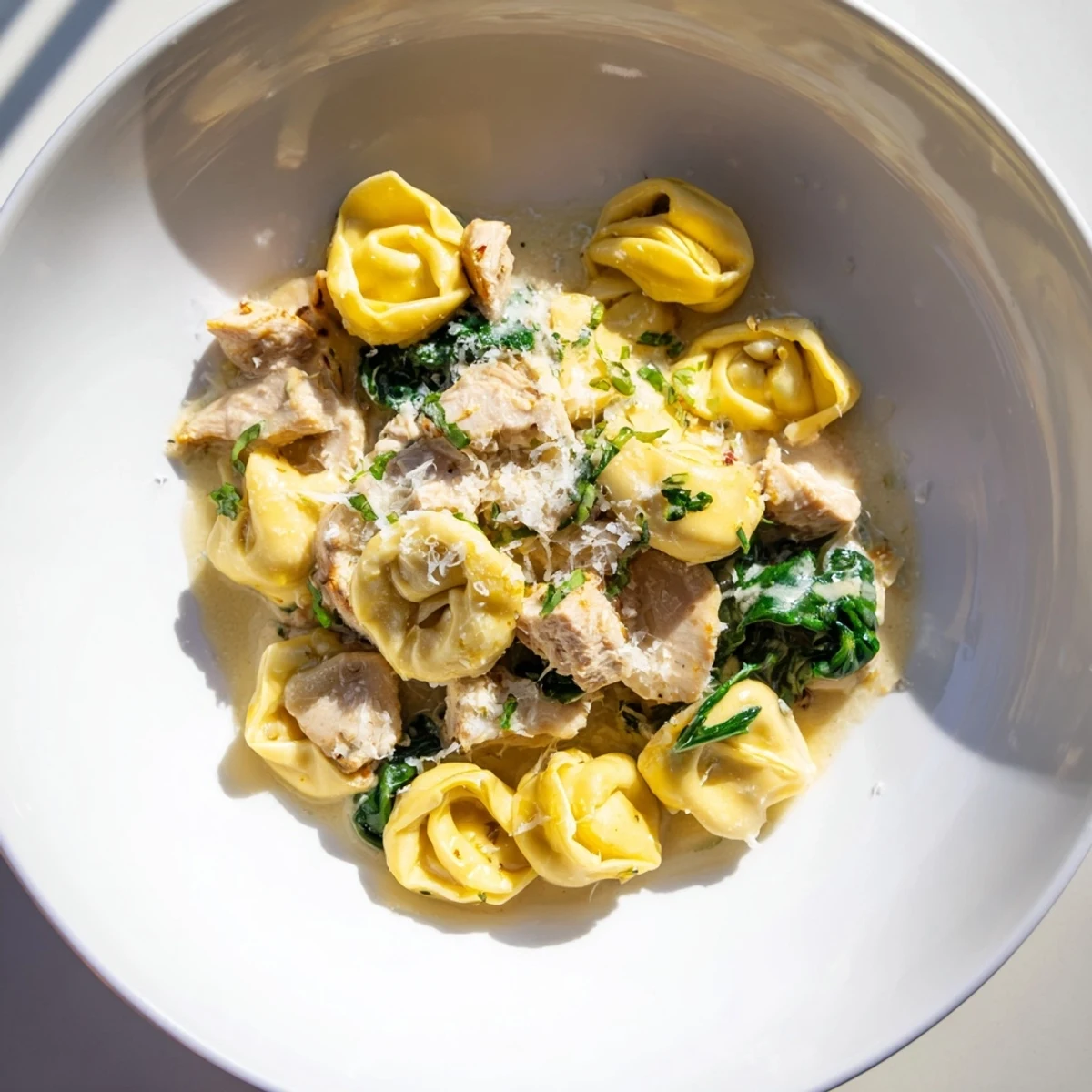 Creamy Chicken and Spinach Tortellini, a rich pasta dish with a creamy Parmesan sauce and tender chicken.