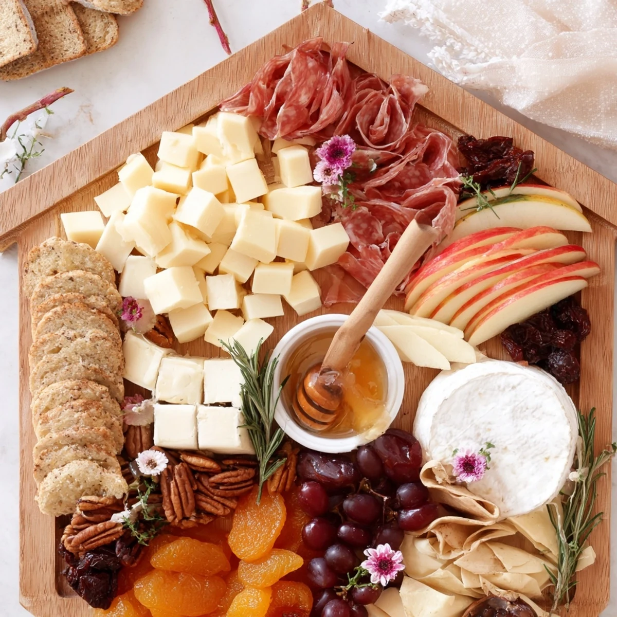 This Sweet Home Charcuterie Board displays a beautiful array of sweet and savory snacks ready to enjoy.