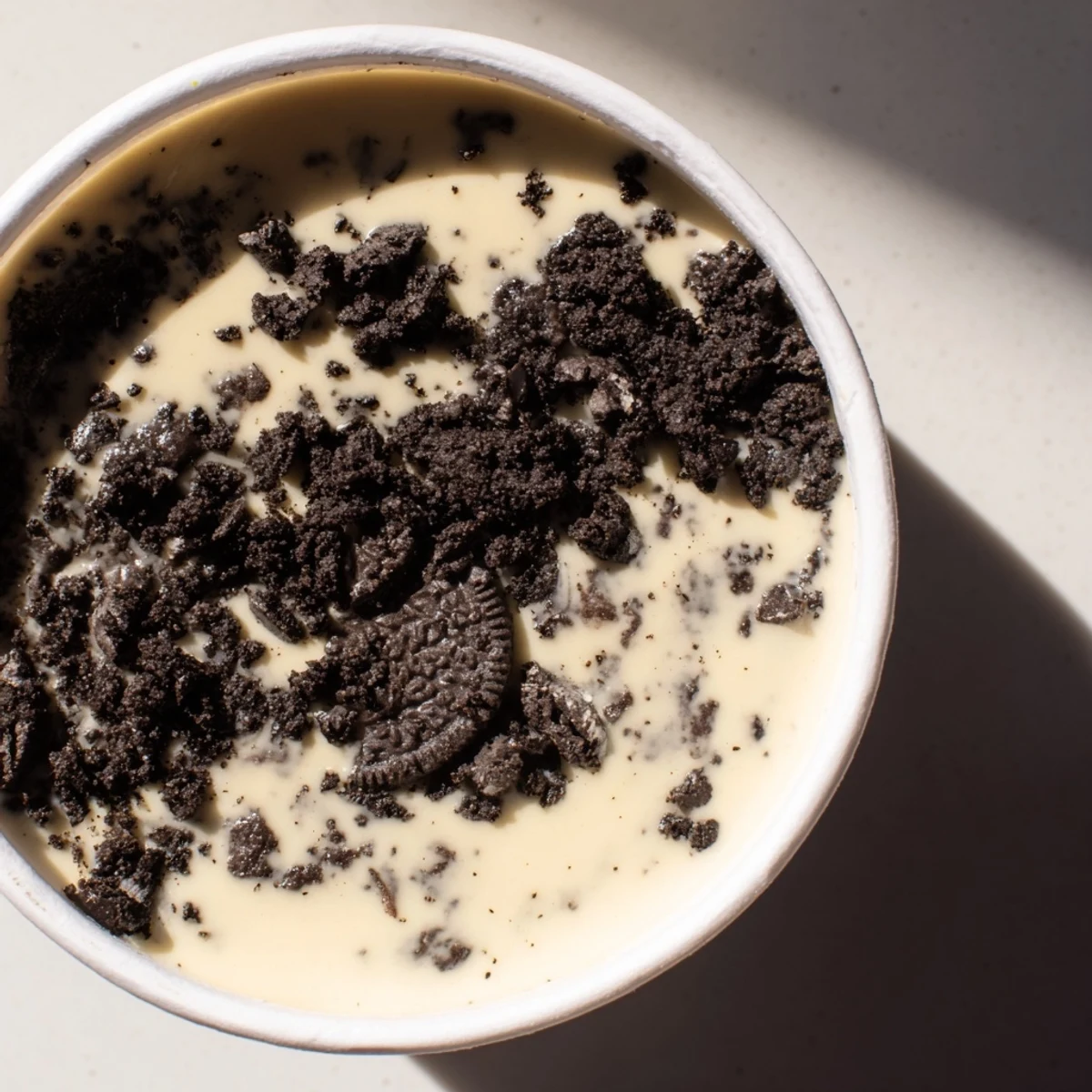 Enjoy a close-up of Vanilla Pudding with crushed Oreos, showcasing the delicious layers topped with cookie crumbles.