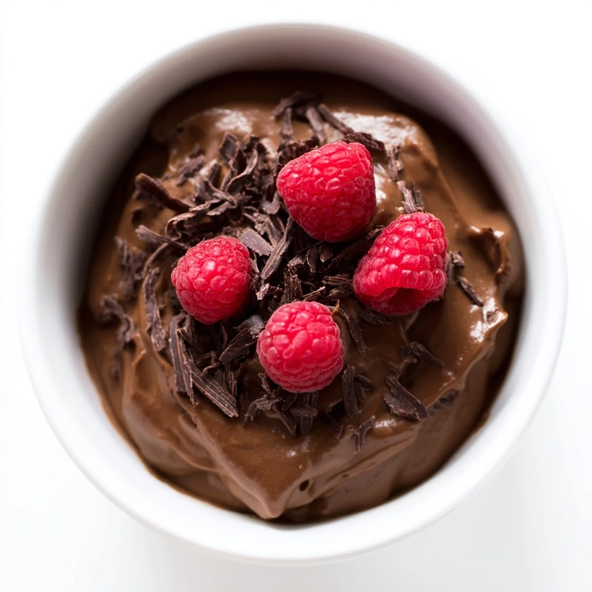 Silky, dark Chocolate Avocado Mousse, topped with fresh berries, a decadent vegan dessert.