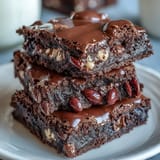 Decadent Cadbury Egg Chocolate Brownies with a rich fudgy base and crunchy crumbled chocolate topping.