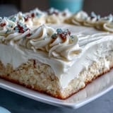 Moist and fluffy sheet cake with creamy vanilla frosting, featuring Class of 2026 piping for a memorable graduation dessert.  