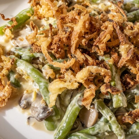 Creamy Old-School Green Bean Casserole topped with crispy fried onions for added crunch.