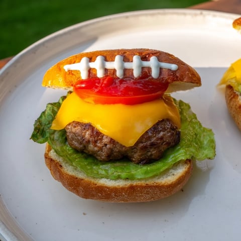 American Football Oval Burger Platter, showcasing mini burgers with melted cheese and fresh toppings, ready to enjoy.