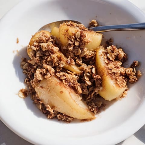 Homemade Spiced Pear Crisp still warm from the oven, showcasing a buttery topping.