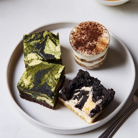 Mini chai tiramisu cups layered with ladyfingers and creamy mascarpone, garnished with cocoa.  