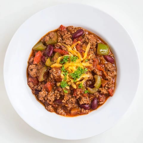 A close-up of a bubbling pot of the hearty quick chili featuring tomatoes, beans and beef.
