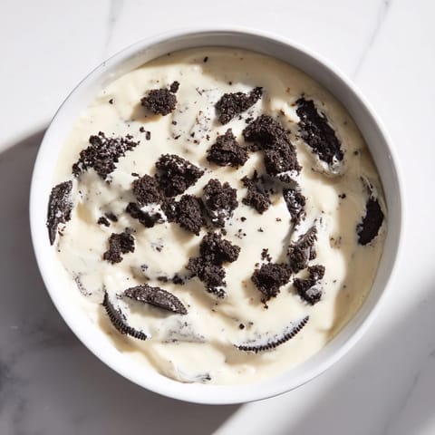 This decadent photo shows Vanilla Pudding with crushed Oreos, ready to eat, with a creamy, textured consistency.