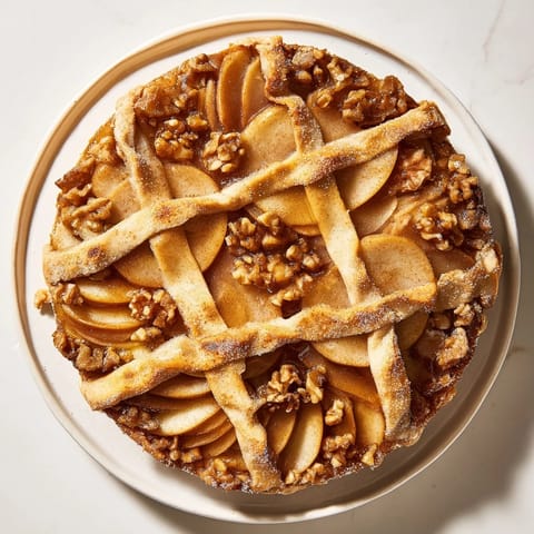 Warm Lattice Orchard dessert, featuring a detailed lattice crust over a sweet walnut filling, so inviting.