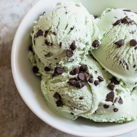 This creamy Mint Chocolate Chip Ice Cream features a swirl of cold, rich, dark chocolate chips.