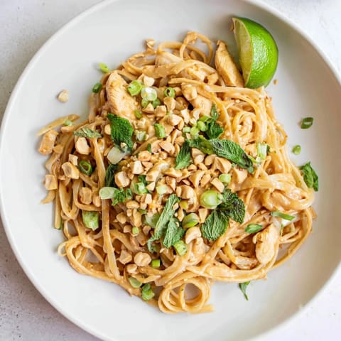 Creamy Thai Peanut Chicken Pasta featuring tender sliced chicken and a flavorful, rich peanut sauce.
