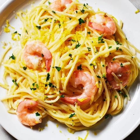 Aromatic garlic and lemon zest sauté creates a zesty, light sauce clinging to delicate pasta and succulent shrimp.  