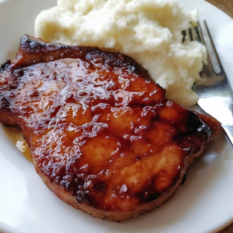 Picture perfect honey glazed pork chops with a sweet and umami flavor, cooked to perfection.