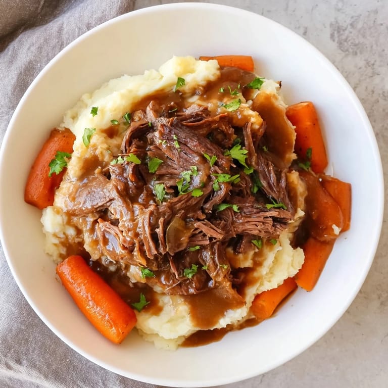 A close-up of a steaming Slow Cooker Pot Roast with vibrant vegetables and creamy potatoes.
