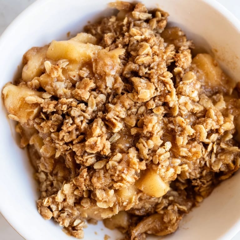 Homemade Apple Crisp showcasing a bubbling apple filling under a crisp, buttery oat topping.