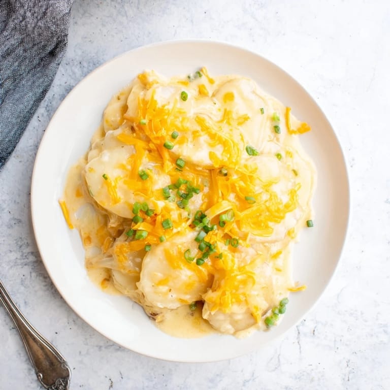 Imagine digging into creamy, rich cheesy scalloped potatoes; a perfect vegetarian dish bubbling in a pan.