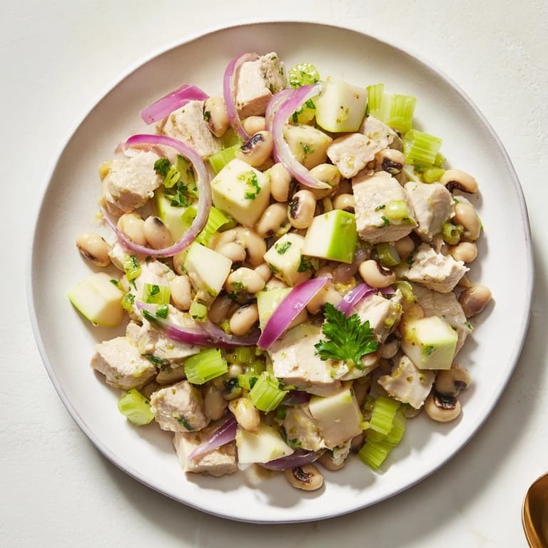 Close-up of a Chicken and Apple New Years Luck Salad, showing juicy chicken and fresh apple slices.